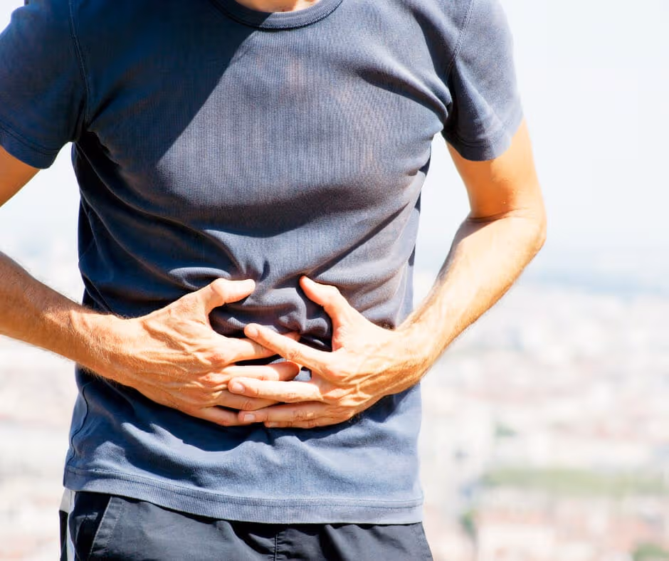 A person experiencing severe stomach pain due to alcohol withdrawal