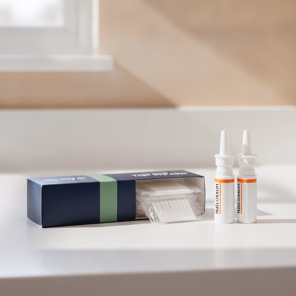 A harm-reduction test strip kit laid out on a clinical surface