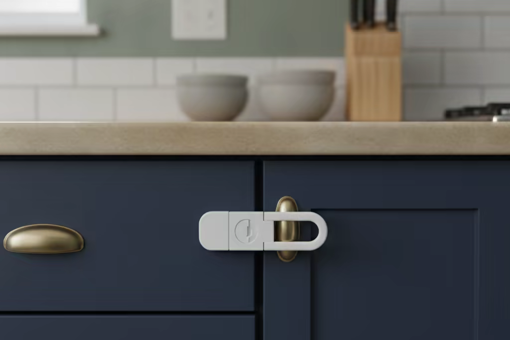 A kitchen cupboard with a childproof latch, photographed at counter height