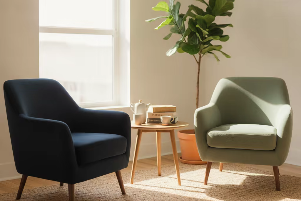 A bright therapy office with two armchairs facing each other beside a window
