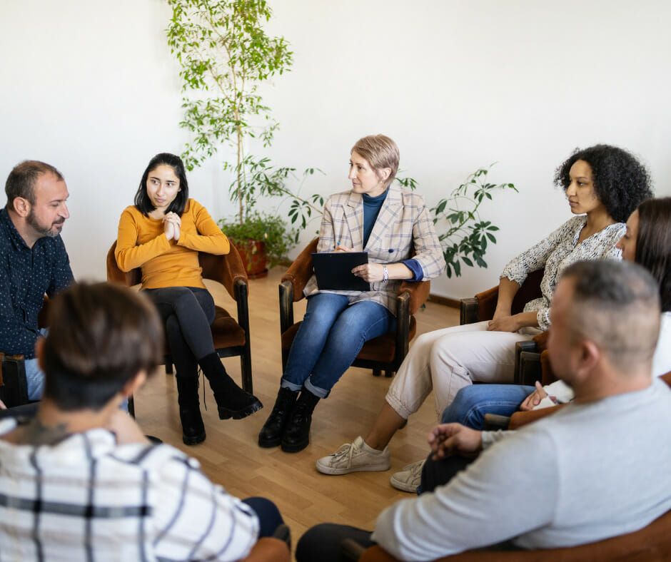 A person attending a support group meeting for 12-step programs
