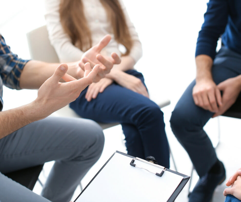 A person in a long-term alcohol rehab program participating in a group therapy session