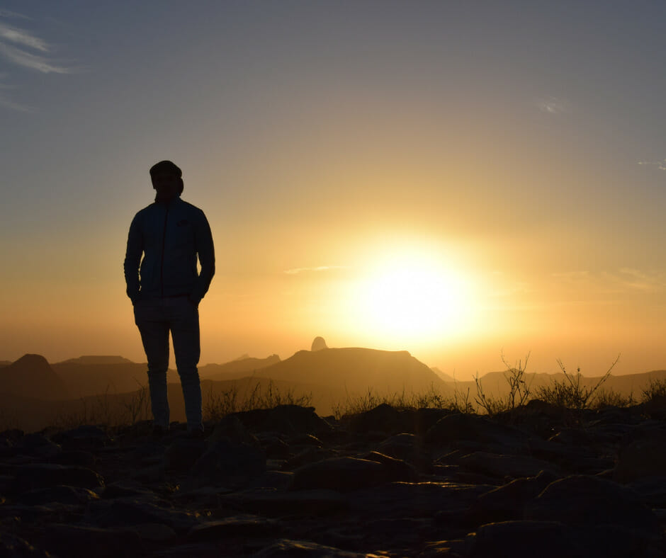 A person looking at a sunset, symbolizing emotional relapse and the need for relapse prevention