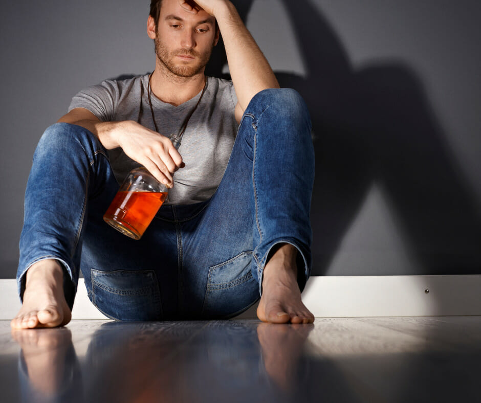 An image showing a person experiencing mild symptoms of alcohol withdrawal, highlighting the potential dangers of alcohol withdrawal.